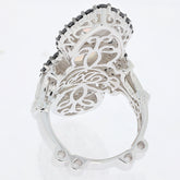 Elegant oval white opa sterling silver ring with intricate detailing and spinel accents on a clear background.